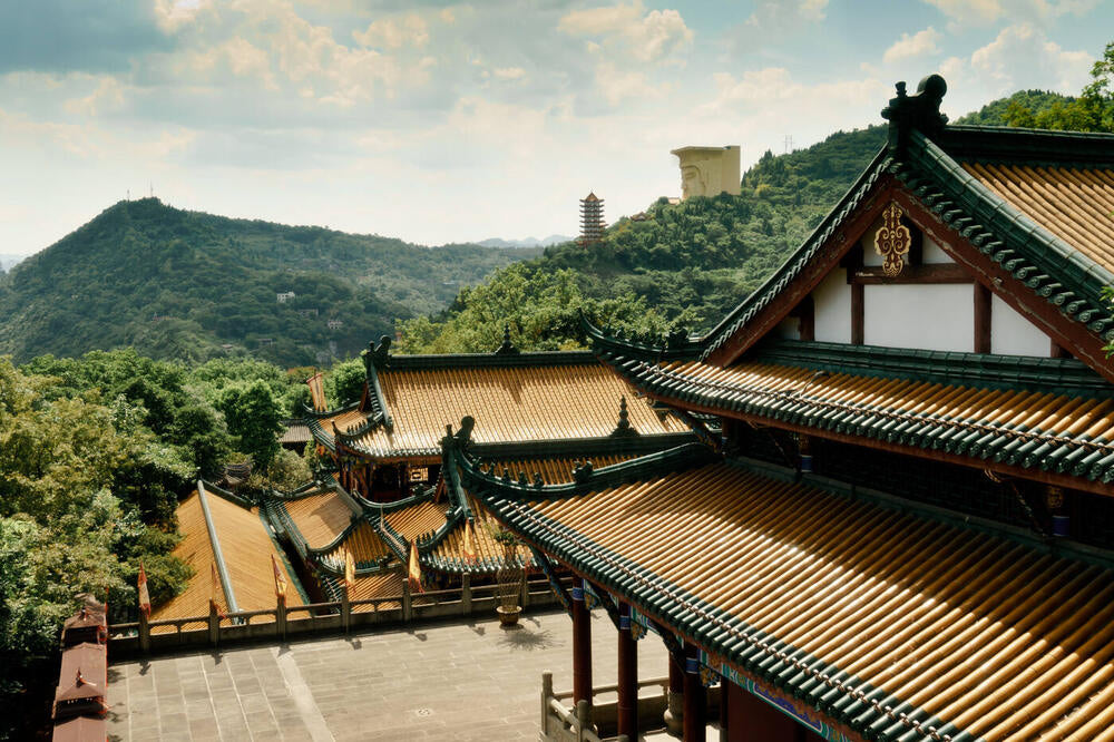 Source photograph: temple rooftops in green hills.